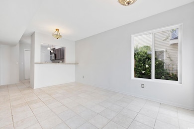Unfurnished living room with light tile flooring