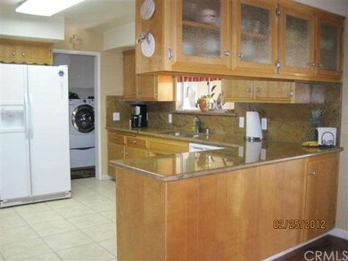 KITCHEN WITH GRANITE AND BEAUTIFUL CABINETRY