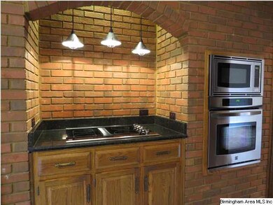 You will love the cook top with arched brick surro