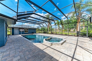 Large sports pool with spa and large paver deck.