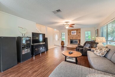 Living area featuring wood finished floors, a cei