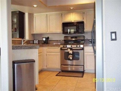 UPDATED KITCHEN WITH TILE FLOORING, GRANITE TILED 