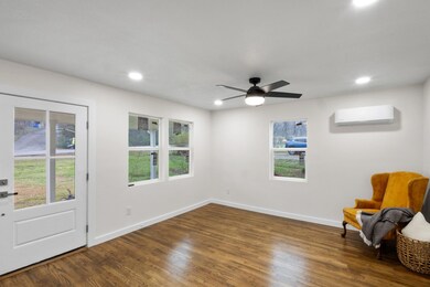 Living area featuring dark wood-type flooring, a w