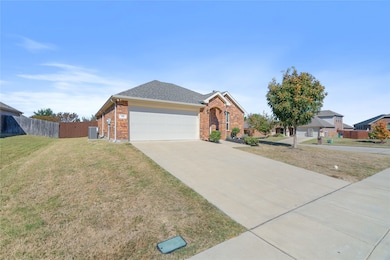 View of front of property with concrete driveway, brick siding, a shingled roof, and an attached garage