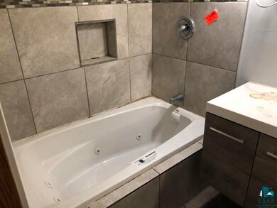 Bathroom with vanity and tile walls