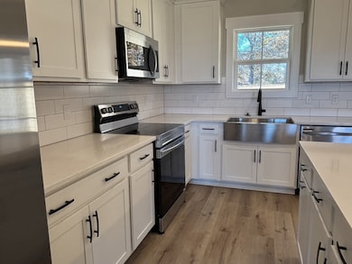 Stainless appliances and a farmhouse sink add beauty.