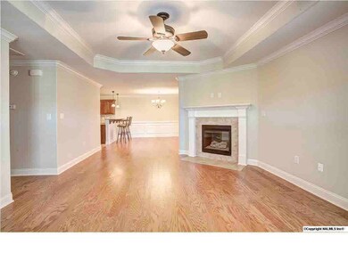 Lovely living room with hardwood flooring, gas log fireplace, and trey ceiling