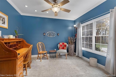 Living area with carpet flooring, ornamental molding, a ceiling fan, and recessed lighting