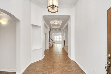The elegant, extended foyer features high ceilings