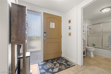 Foyer entrance with light tile patterned floors