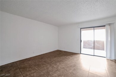 Living room with sliding door access to balcony