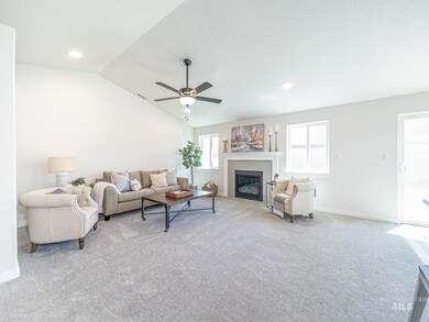 Living area featuring light colored carpet, a glass covered fireplace, a ceiling fan, lofted ceiling, and recessed lighting