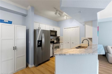 Kitchen with white cabinets, stainless steel appli