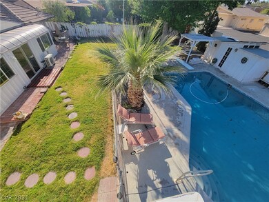 Large backyard with fenced pool.