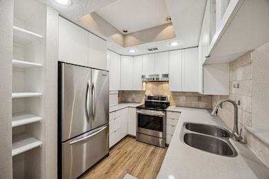 Stainless steel appliances, recessed lighting and plenty of counter space. Breakfast bar wraps around the kitchen.