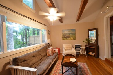Open Bright living area with sturdy wood beam!