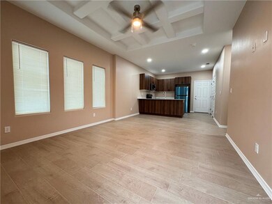 Unfurnished living room with light hardwood / wood-style flooring, ceiling fan, beam ceiling, coffered ceiling, and sink