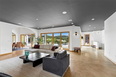 Living area featuring recessed lighting, arched w