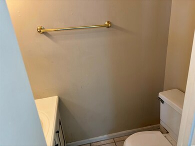 Bathroom featuring toilet, tile patterned flooring