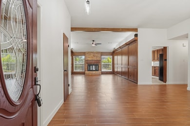 Open entry draws you toward the bright living room and backyard views.