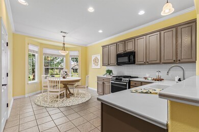 Kitchen featuring stainless steel gas range, blac