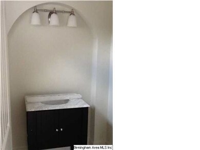 A half bath with arched mirror frame is another fo