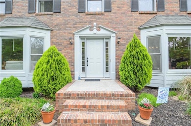 View of exterior entry featuring brick siding
