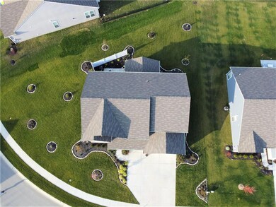 Aerial view of the pie-shaped lot that is fully-landscaped.