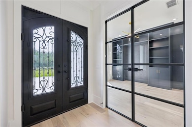 Entrance foyer with french doors and wood finished floors