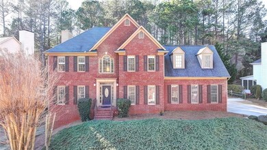Colonial-style house featuring roof with shingles,