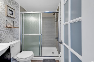 Bathroom featuring vanity, a shower with shower do