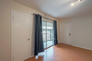 To the left of the sliding glass door is a large,