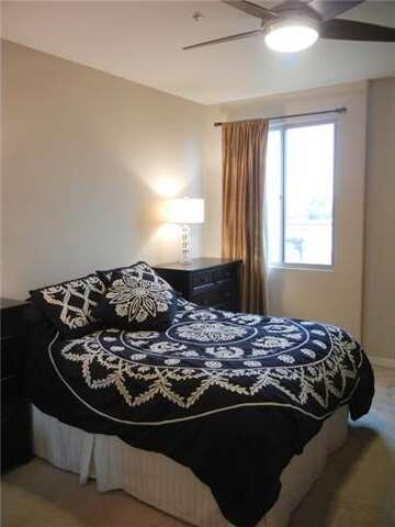 Master bedroom has ceiling fan and lots of natural