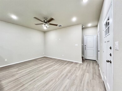 Living room featuring light wood-style flooring, recessed lighting, and a ceiling fan
