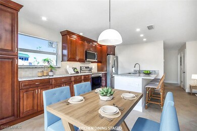 Kitchen featuring light tile patterned floors, sta