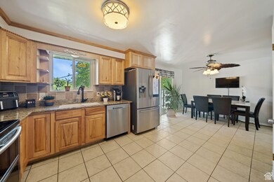 Kitchen featuring decorative backsplash, dark stone counters, and healthy amount of natural light