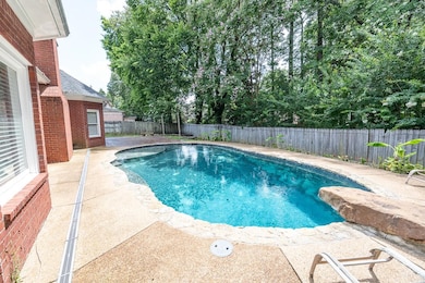 View of swimming pool featuring a patio area and a fenced backyard