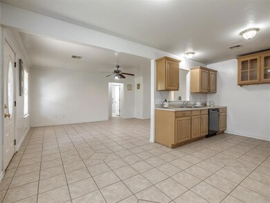 Kitchen with light tile patterned flooring, black 