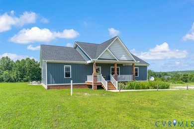 View of front of home featuring board and batten siding, covered porch, a front yard, and a shingled roof