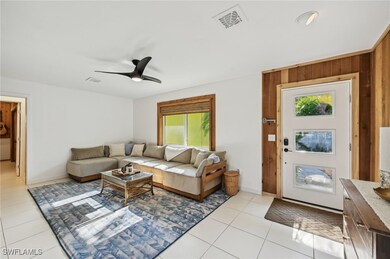 Living room featuring ceiling fan, a wealth of nat