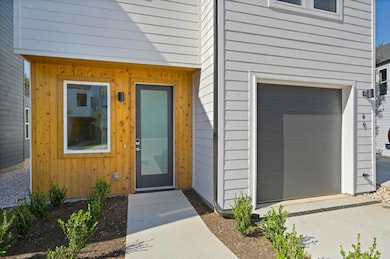 Doorway to property featuring an attached garage 