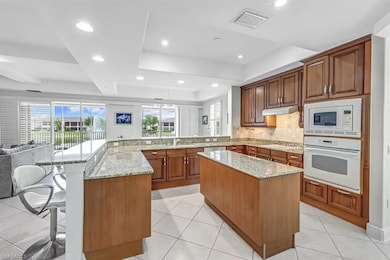 Kitchen featuring white appliances, a tray ceiling