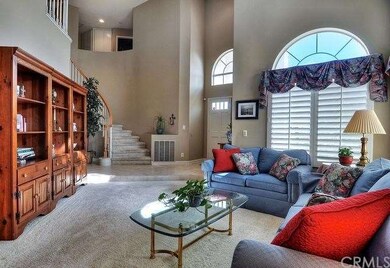 Two-story entry leads to large living room accente