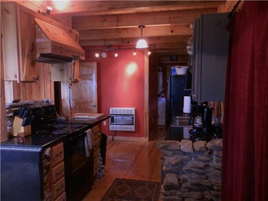 Open kitchen with granite counters and stacked stone work.