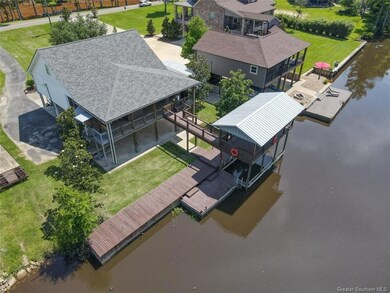 Exterior of home with view of wharf/boat house and