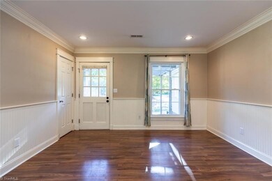 Dining room with laminate flooring and wainscoting