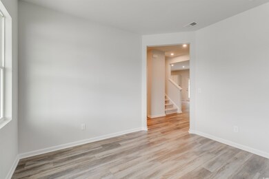Empty room with recessed lighting, visible vents, baseboards, stairway, and light wood finished floors