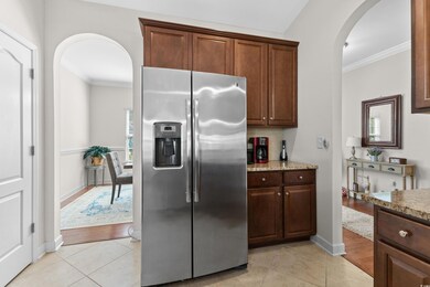 Kitchen with crown molding, stainless steel fridge