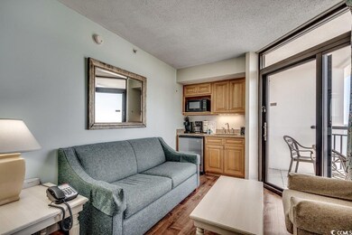 Living room with dark wood-style floors, wet bar, 