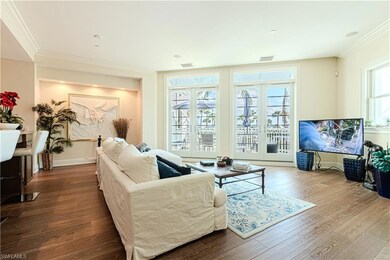 Living room with baseboards, wood finished floors,